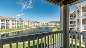 A row of apartment buildings with a body of water in front
